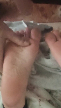 Playing with Friends Soles, While She's Reading.