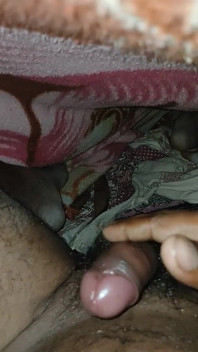 Big Boss massaging penis oil under the blanket