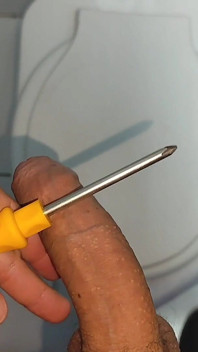 Young Straight Man Inserting the Tool Through the Glans.