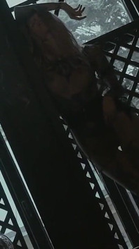 Tattooed teen is dancing in the dark room