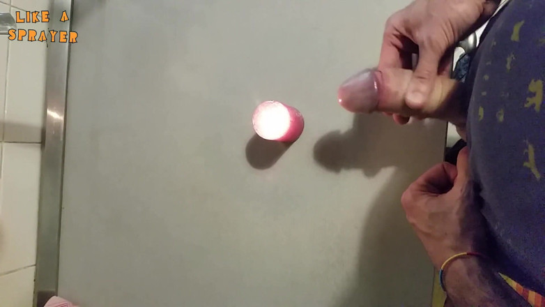 Like a sprayer: Candle cumshot by handjob