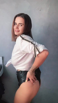 A Brunette in a White Shirt Is Ready to Bare Her Big Breasts