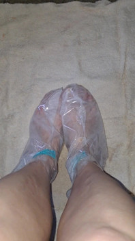 Pedicure Step Feet in Plastic Foot Mask Booties