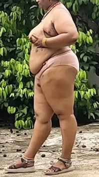 A Full-figured Woman in a White Skirt and Pink Top Strips Down and Walks Nude Outside