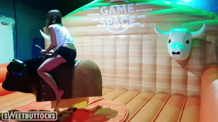 SweetButtocks: Hot Brunette with Big Tits Saddled Bull in Amusement Park