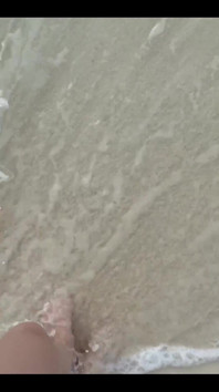 Running My Bare Feet on the White Beach Sand by the Ocean
