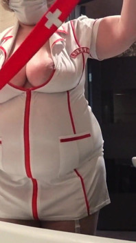 Big Boobs. Gorgeous Cleavage Under a Medical Gown. a Mature Nurse on Camera at Work