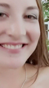 帽子をかぶった赤毛の女性が下手でレザーソファに乗っている