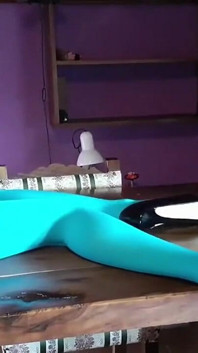 MILF with Beautiful Legs in Pantyhose and Heels Lying on the Table