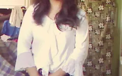 Jhazmeena Wearing a White Blouse and a Pleated Black Retro Flower Print Skirt