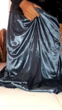 Travestiet komt klaar met satijnen zijden blouse en glanzende rok