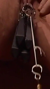 Chained Cougar Gets Her Pussy Heavily Clamped and Weighted