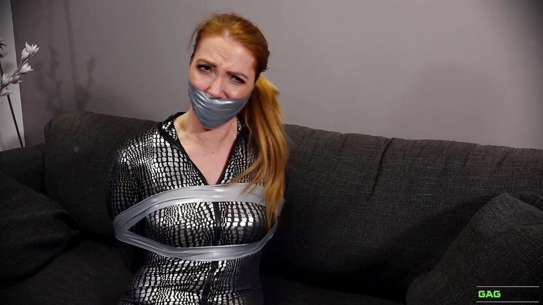 Gag Attack: Mila - Red head catsuit crook in tape bondage