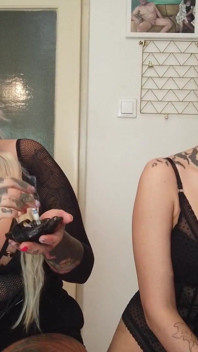 Tattooed ladies smoking in the kitchen