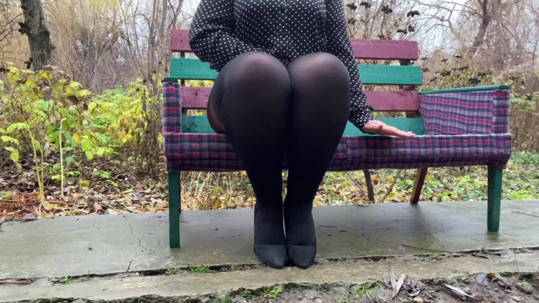 Elena: Depraved curvy MILF masturbates sitting on a bench through torn...