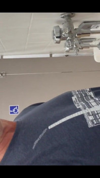 Pissing at a urinal with no dividers.