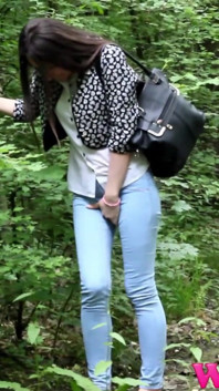 Desperate Brunette in a Forest Holding Her Crotch to Stop Herself From Pissing in Her Jeans