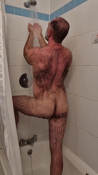 Un beau-père poilu et musclé prend une douche