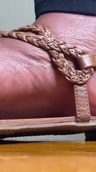 Kaki eboni dalam sandal coklat mengusik