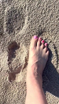 Comparing Size 16 Feet to Sand Prints at the Beach
