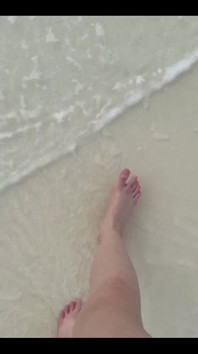 Running My Bare Feet on the White Beach Sand by the Ocean