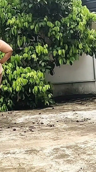 A Full-figured Woman in a White Skirt and Pink Top Strips Down and Walks Nude Outside