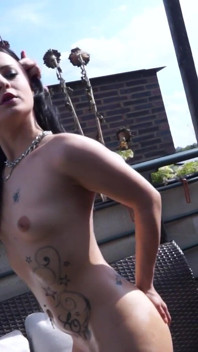 Hot and tattooed brunette is smoking a cigar and masturbating outdoors