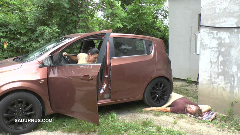 Sadurnus: Mistress Jenna Stands on the Slave with a Car While...