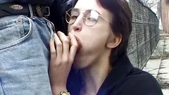 Threesome blowjob scene outdoors