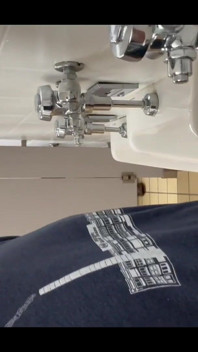 Pissing at a urinal with no dividers.