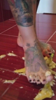 A banana is trampled by a blonde tattooed MILF