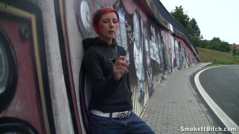 Smoke it bitch: Girl with colored hair & a pierced face smokes a cigar...