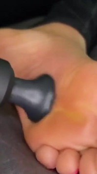 Ebony Girl Gives Her Feet a Massage with a Massage Gun