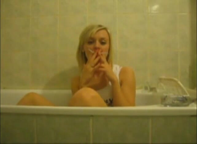 Femdom Austria: Blonde bitch in the bathtub smoking cigarettes