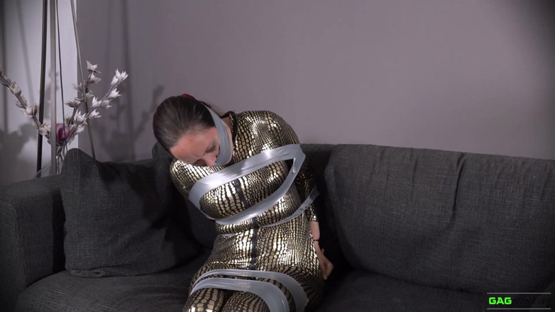 Gag Attack: Leila - Catsuit crook in tape bondage