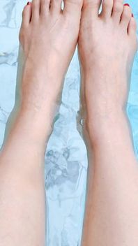 The Mistress Soaked Her Beautiful Feet in the Swimming Pool.