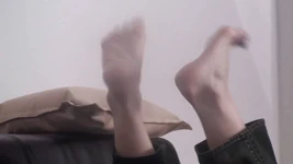 Les pieds de Xenia pendants à la musique