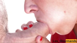 MILF in sexy red leather dress gives close-up blowjob and swallows cum to play with in her hands