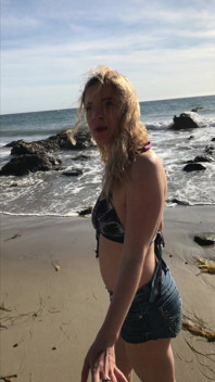 Model blows on the beach