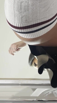Miniskirt Lover Raver Girl Reveals Her Piercing on Her Pussy in the Bathroom by Lifting Her Short Skirt