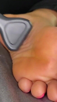 Ebony Girl Gives Her Feet a Massage with a Massage Gun