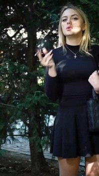 Hot Blonde Babe Smoking Two Black Cigarettes in Nature