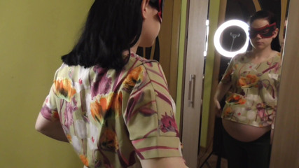 Anna Sky: Pregnant Anna trying on dresses in front of a mirror