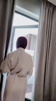Hijab-wearing Woman Bathes Naked in an Open Swimming Pool