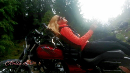 Abella Love: Red lips blonde smoking sensually on Rasta bike outdoor