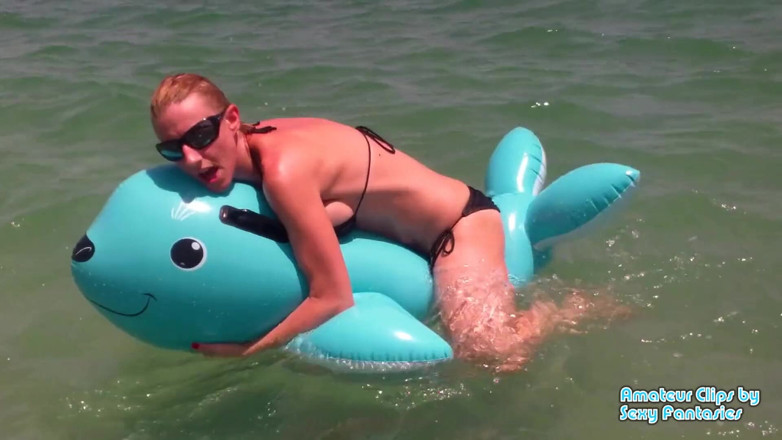 Brittany Lynn: Humping blue inflatable toy in the water at a beach...