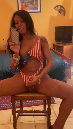Beautiful Brazilian transexual Luciana Foxx masturbates in front of mirror thumbnail