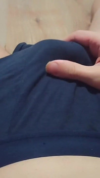 A Young Athletic Guy in Blue Shorts Is Massaging His Penis