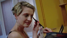 Teresa Suarez puts makeup on her face