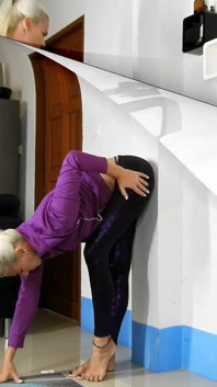 Sensual Wall Stretching in Shiny Purple Leggings